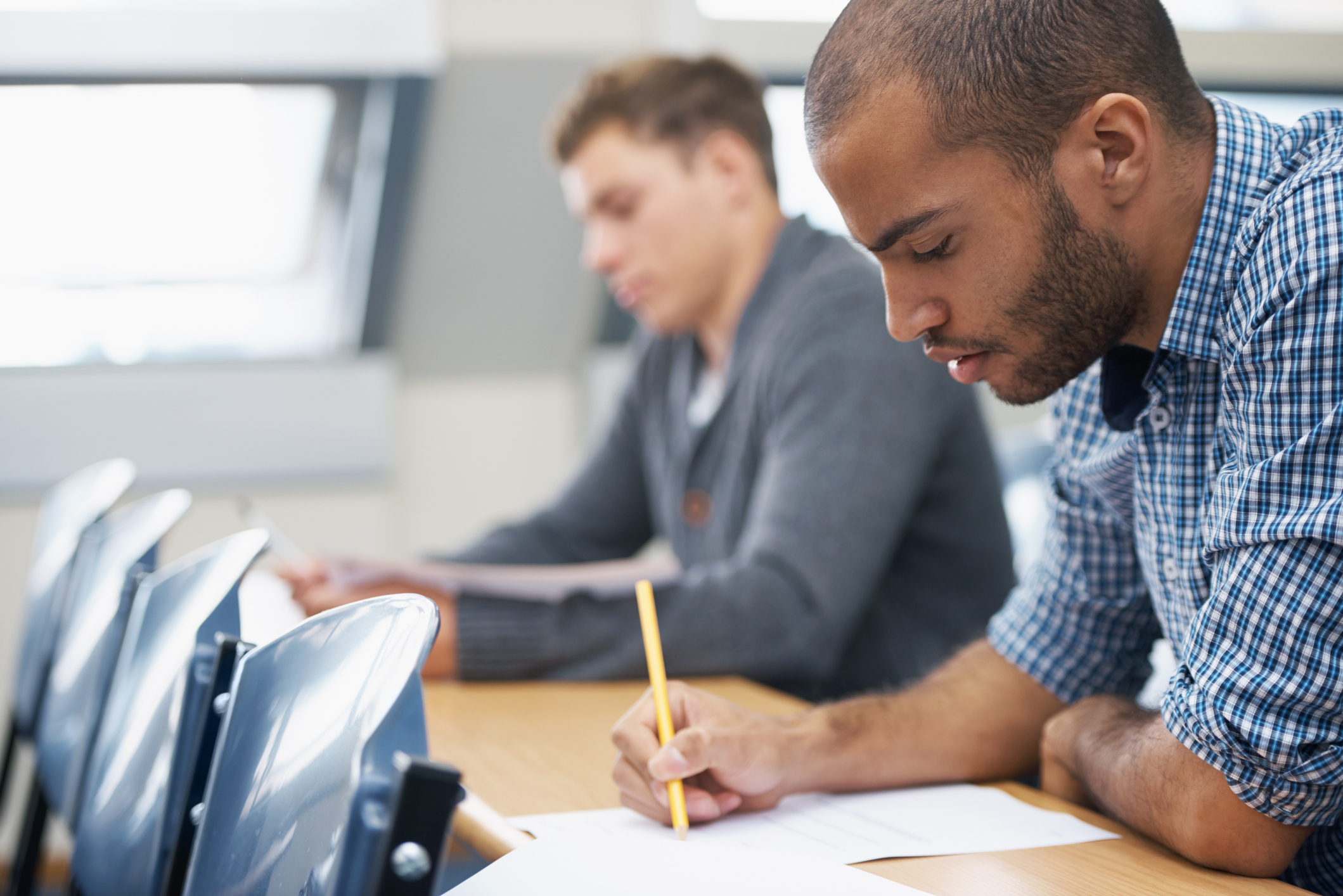 Two students taking written exam